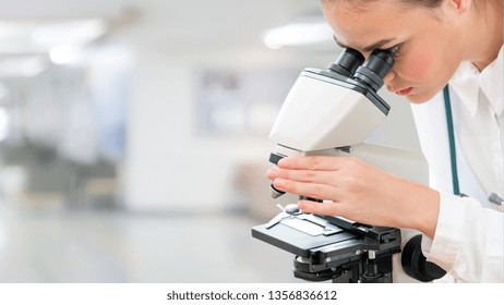 Scientist Researcher Using Microscope In Laboratory. Medical Healthcare Technology And Pharmaceutical Research And Development Concept.