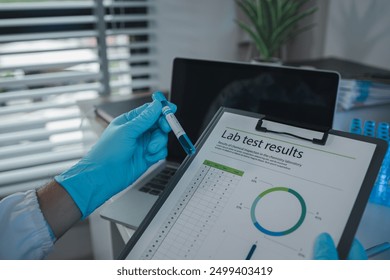 A scientist is reviewing lab results and documents receives from researchers involved in chemical testing, chemist is concentrating on reading test results document - Powered by Shutterstock