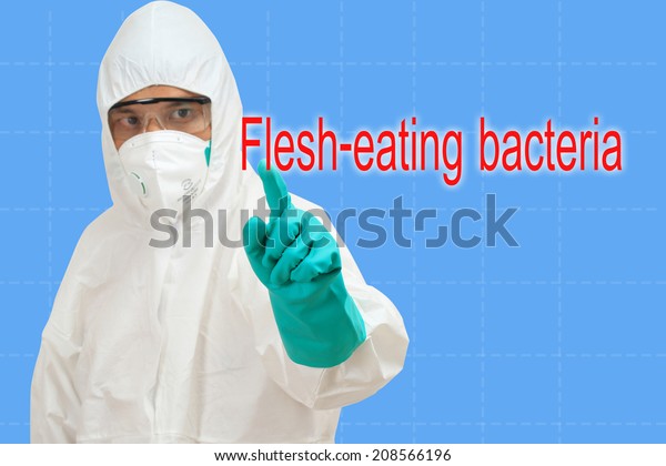 scientist in safety suit pointing to word flesh-eating bacteria