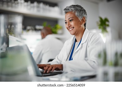 Scientist, senior woman and lab with laptop, research and plants with analytics, pharmaceutical study and focus. Elderly science expert, computer and typing for data analysis for goal in laboratory - Shutterstock ID 2256514059