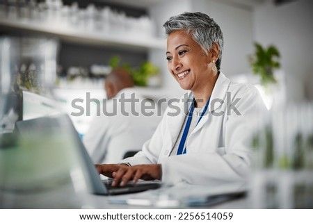 Scientist, senior woman and lab with laptop, research and plants with analytics, pharmaceutical study and focus. Elderly science expert, computer and typing for data analysis for goal in laboratory