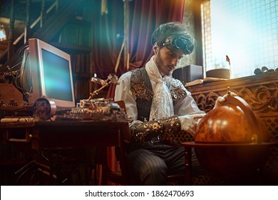 Scientist Steampunk Man Inventor Works In His Laboratory With Victorian Interior. Adventure World Of Steampunk.