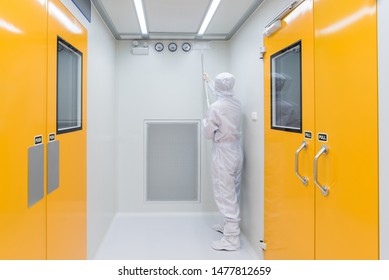 A Scientist In Sterile Coverall Gown Using Cleaning Tool For Cleaning Laboratory. Cleanroom Facility.
