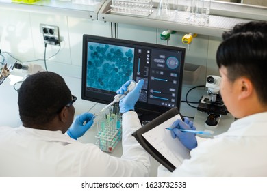 Scientist and students working in lab. Doctor teaching interns to make blood analyzing research. Biotechnology, chemistry, bacteriology, virology and health care concept. - Shutterstock ID 1623732538