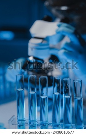 A scientist is studying samples using a microscope to study and develop the field of microbiology, Microscopes are used by researchers to study chemotherapy.