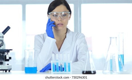 Scientist Talking on Phone in Laboratory - Powered by Shutterstock