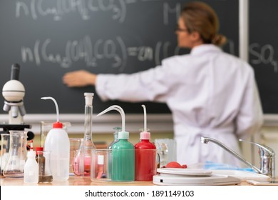 Scientist Teacher Explaining How To Read A Chemical Equation  During A Chemistry Lesson