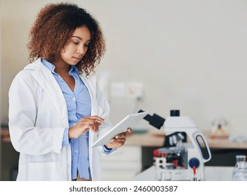 Scientist, test and woman in lab with tablet reading info, data or study research online for vaccine. Science, tech and person check results of medical experiment or analysis of virus and bacteria - Powered by Shutterstock