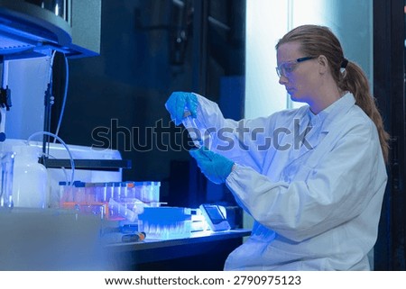 scientist testing water quality sample for microplastics and chemical contaminants in laboratory.