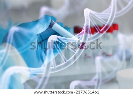 Scientist with tube and virtual screen with data scientific at genetic engineering lab. Biomedical engineer genetic working with tubes in biotechnical laboratory