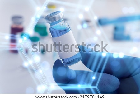 Scientist with tube and virtual screen with data scientific at genetic engineering lab. Biomedical engineer genetic working with tubes in biotechnical laboratory