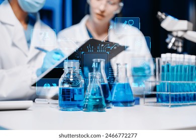 Scientist two woman with tablet and laptop, laboratory and ecofriendly science. Agriculture, research and scientists with online reading, test samples for global warming, analytics and tech.
 - Powered by Shutterstock