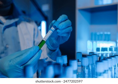 A scientist uses laboratory equipment for a research experiment, test tube is essential for chemists to use in experiments, scientific researchers must concentrate on testing samples in the lab - Powered by Shutterstock