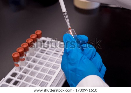 A scientist using a micropipette  