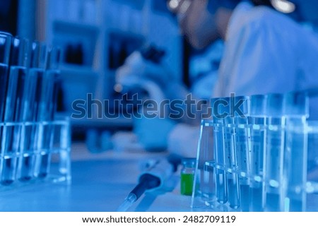 scientist is using microscope in laboratory, chemical researcher works in chemistry with concentration, chemist is conducting a science experiment using a microscope to test experimental substances