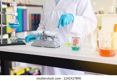 Scientist Using The Tongs Weighing Medicine Or Medical Chemicals Sample In Test Tube At Lab