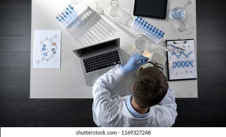 Scientist Viewing Samples Under Microscope, Research For Scientific Article