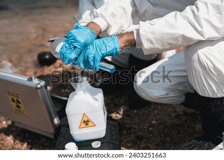 Scientist wear protection suit checking chemical and water analysis and water quality from factory. Protecting Against Hazards and Contamination.