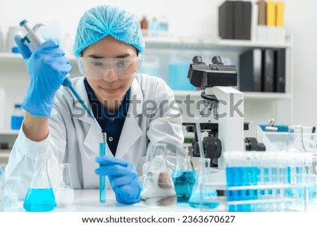Scientist wearing glassware research in chemistry laboratory for pharmaceutical using beaker and test tube equipment for analysis microbiology