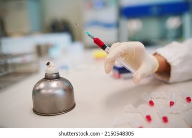 Scientist Wearing Medical Gloves Use Syringe Mix Red Color Solutions For Carbohydrate Fermentation Test, Acid Detection, Laboratory Concept.