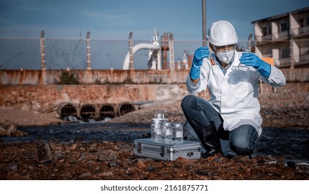 Scientist wearing protective  uniform and glove under working water analysis and water quality by get waste water to check case in laboratory is environment pollution problem concept. - Powered by Shutterstock