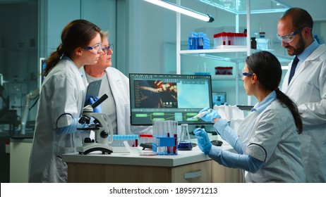 Scientist Woman Pipetting Liquid To Test Tube Working In Equipped Lab Late At Night. Chemists Examining Virus Evolution Using High Tech For Scientific Analysis Of Treatment Development Against Covid19