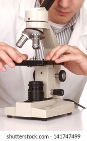 Scientist At Work Using a Microscope on White