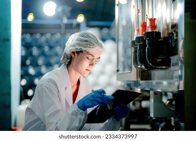 scientist worker checking the quality of Reverse osmosis machine system at the industrial factory. Female worker recording data at the control panel with measure pressure for recycle portable plant.