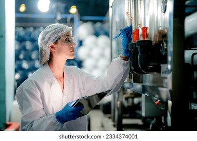 scientist worker checking the quality of Reverse osmosis machine system at the industrial factory. Female worker recording data at the control panel with measure pressure for recycle portable plant. - Powered by Shutterstock