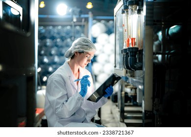 scientist worker checking the quality of Reverse osmosis machine system at the industrial factory. Female worker recording data at the control panel with measure pressure for recycle portable plant. - Powered by Shutterstock