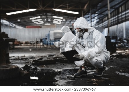 Scientist workers wear protection suit checking chemical contaminated oil in old factory. Protecting Against Hazards and Contamination. Emergency Response to a Radioactive Accident.