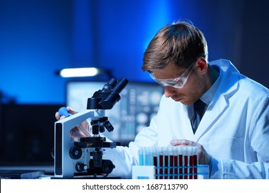 Scientist Working In Lab. Doctor Making Microbiology Research. Laboratory Tools: Microscope, Test Tubes, Equipment. Coronavirus Covid-19 , Bacteriology, Virology And Health Care.