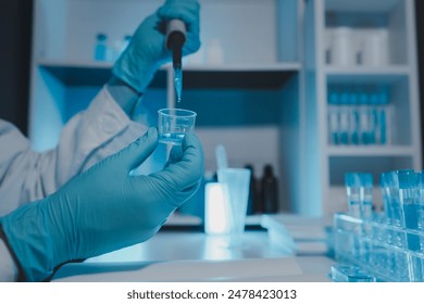 a scientist is working in a laboratory, a chemical researcher is preparing sample for a vaccine against a virus, work in lab concentrate is the most important because chemicals are dangerous - Powered by Shutterstock