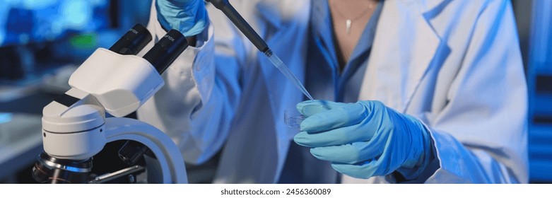 Scientist Working in the laboratory using a Micro Pipette. Mixing liquid chemicals with genetically modified samples under a microscope biotechnology, microbiology development, research experiments.