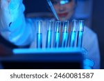 Scientist working in laboratory using micropipette Mixing liquid chemicals with genetically modified samples under a biotechnology microscope. Development of microbiology research experiment.