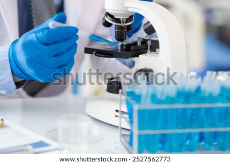 Scientist working microscope doing research in laboratory. Scientist in a lab, adjusting a microscope, evoking precision and scientific inquiry.