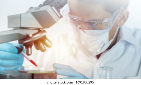 Scientist working with microscope in lab. Laboratory research concept.
About experimental science such as chemical mixing or data entry to develop vaccines for everyone in the world.
