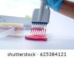 Scientist working with multichannel pipette.Blood test labboratory