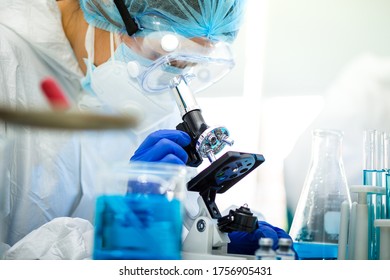 Scientist Working On Coronavirus Vaccine At Lab. 
Abstract Of Analyzing Covid 19 Sample With Microscope And Holding Coronavirus Covid 19 Blood Sample Tube In Laboratory.