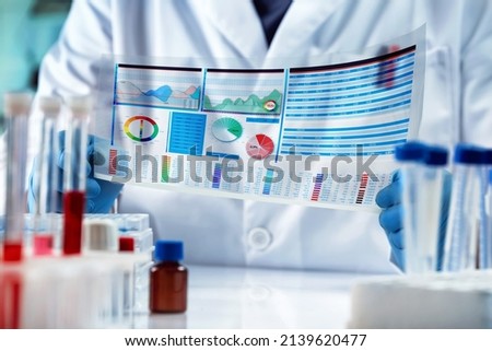 Scientist working on experiment data analysis in Science Biotechnology Development. Researcher Analyzing Test Results Report in Medical Research Laboratory