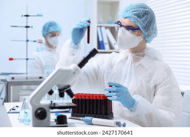 Scientist working with samples in test tubes in laboratory