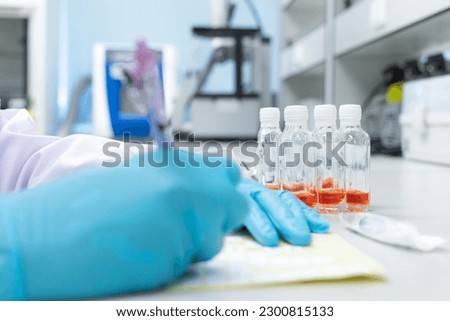 Scientist writing text and use coliform test for testing water or ice in chemistry laboratory.