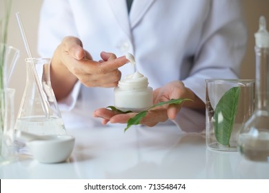 the scientist,dermatologist applying the organic natural cosmetic cream.research and development beauty skincare.testing product.blank package,bottle,container.