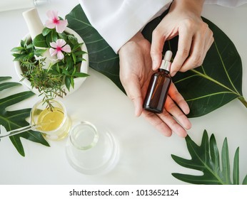 the scientist,dermatologist with the organic natural product in the laboratory.research and development beauty skincare concept.blank package,bottle,container .cream,serum.hand. - Powered by Shutterstock