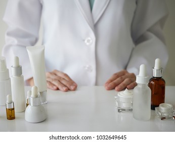 the scientist,dermatologist testing the organic natural cosmetic product in the laboratory.research and development beauty skincare concept.blank package,bottle,container .cream,serum.hand