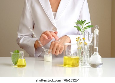 the scientist,dermatologist testing the organic natural cosmetic product in the laboratory.research and development beauty skincare concept.blank package,bottle,container .cream,serum.hand
