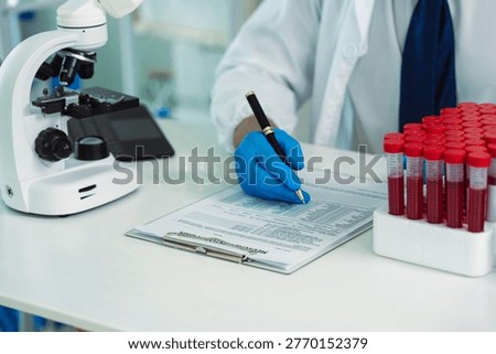 Scientists are analyzing blood samples in a laboratory related to medical research and development, blood analysis, and biotechnology.