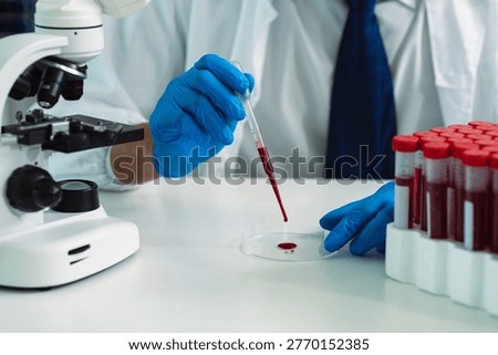 Scientists are analyzing blood samples in a laboratory related to medical research and development, blood analysis, and biotechnology.