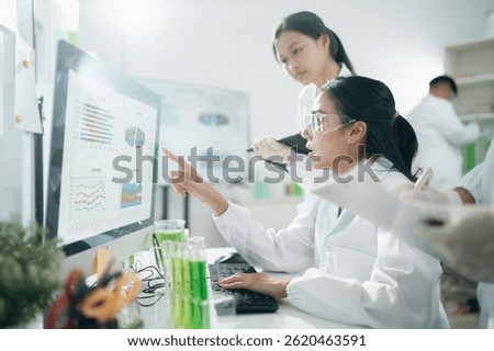 Scientists analyzing data results on laboratory computer monitors, focusing on research, innovation, experiment, teamwork, and biotechnology in modern lab environments for scientific development