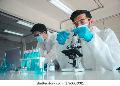 Scientists or doctor are testing drugs to prevent and destroy new strains of the virus through microscope.  Researching and experimenting for effective chemicals. Protect and repair. COVID-19